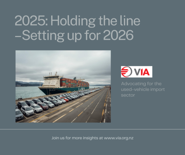 Roll-on/roll-off vessel at a New Zealand port with rows of imported vehicles on the wharf